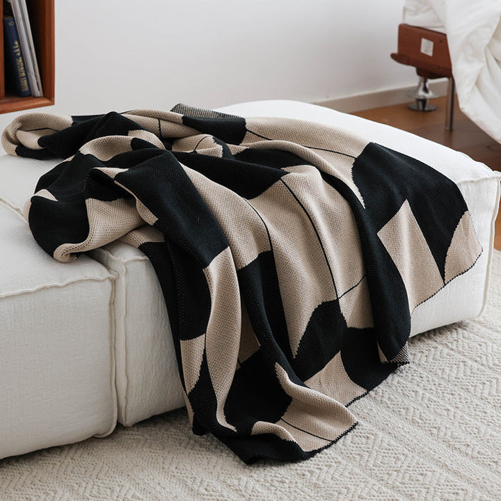 Plaid géométrique réversible moderne, motif tricoté élégant, parfait pour le confort et la décoration intérieure.