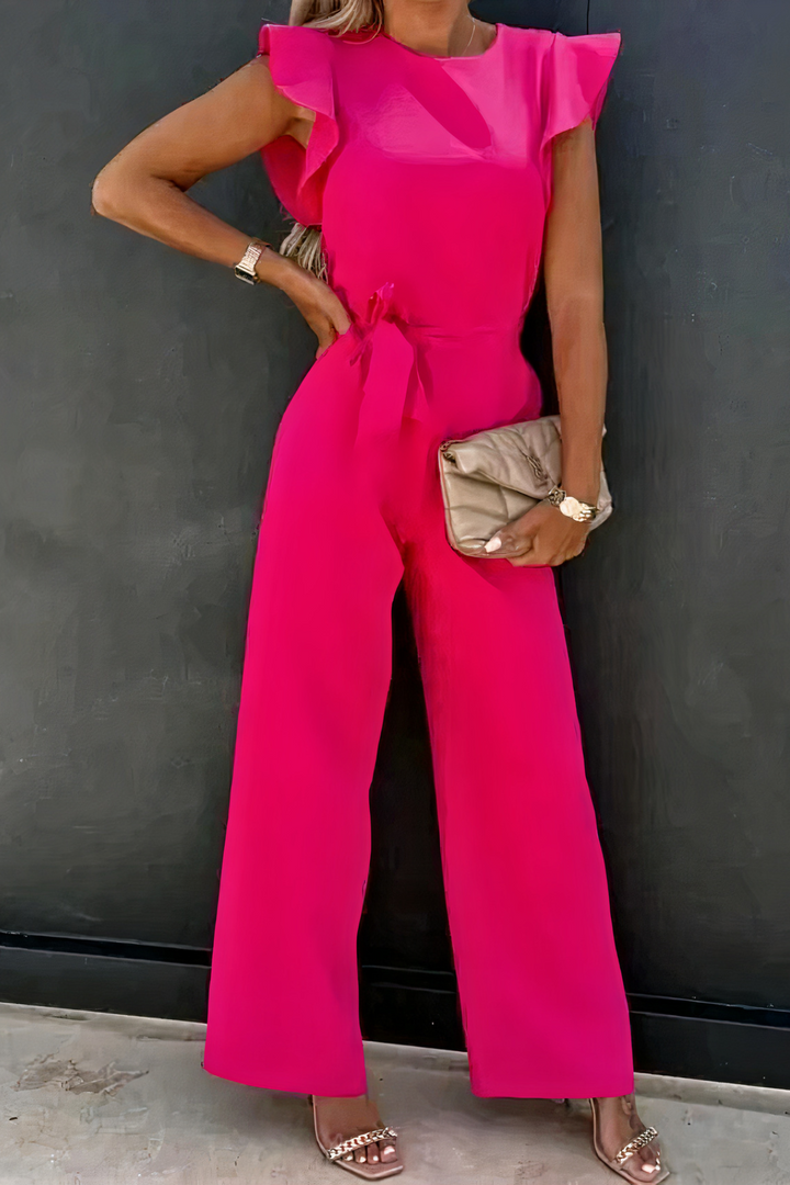 Détail des volants délicats et de la ceinture nouée sur cette combinaison femme chic à jambes larges et col rond.