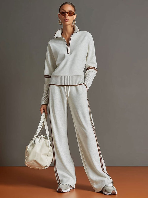 Ensemble loungewear femme polyvalent, haut zippé et pantalon large décontracté, parfait pour homewear ou sport chic.