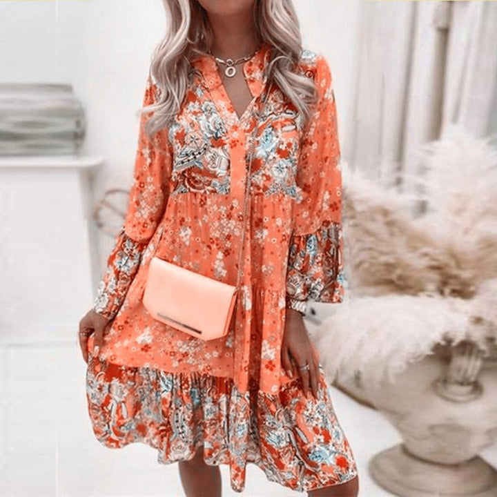 Robe femme midi florale bohème avec manches longues et col V. Idéale pour un look printemps-été.