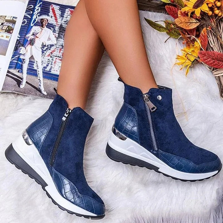 Détail bottines femme en cuir noir, talon épais, avec fermeture éclair latérale, élégantes et confortables.
