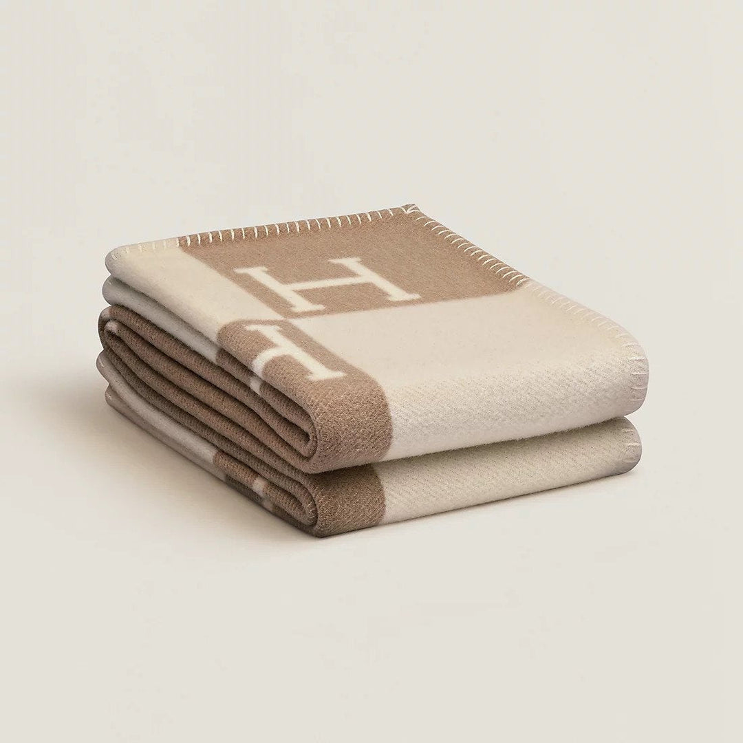 Texture douce et luxueuse d'un plaid en cachemire et laine, détail de confort hivernal.
