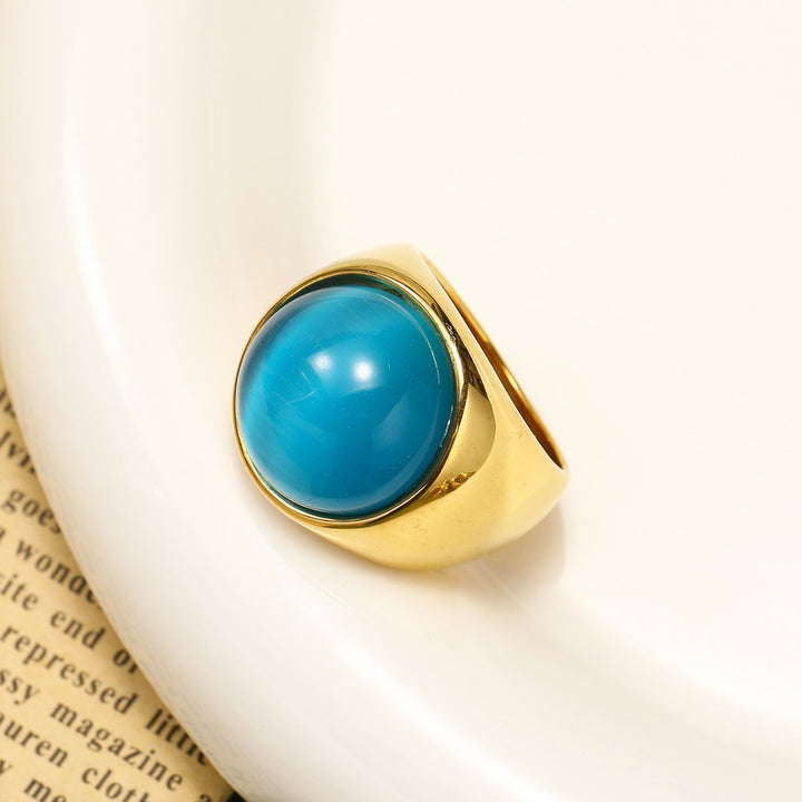 Bague bijoux femme, pierre Oeil de Chat couleur corail, design raffiné, cadeau idéal pour anniversaire.