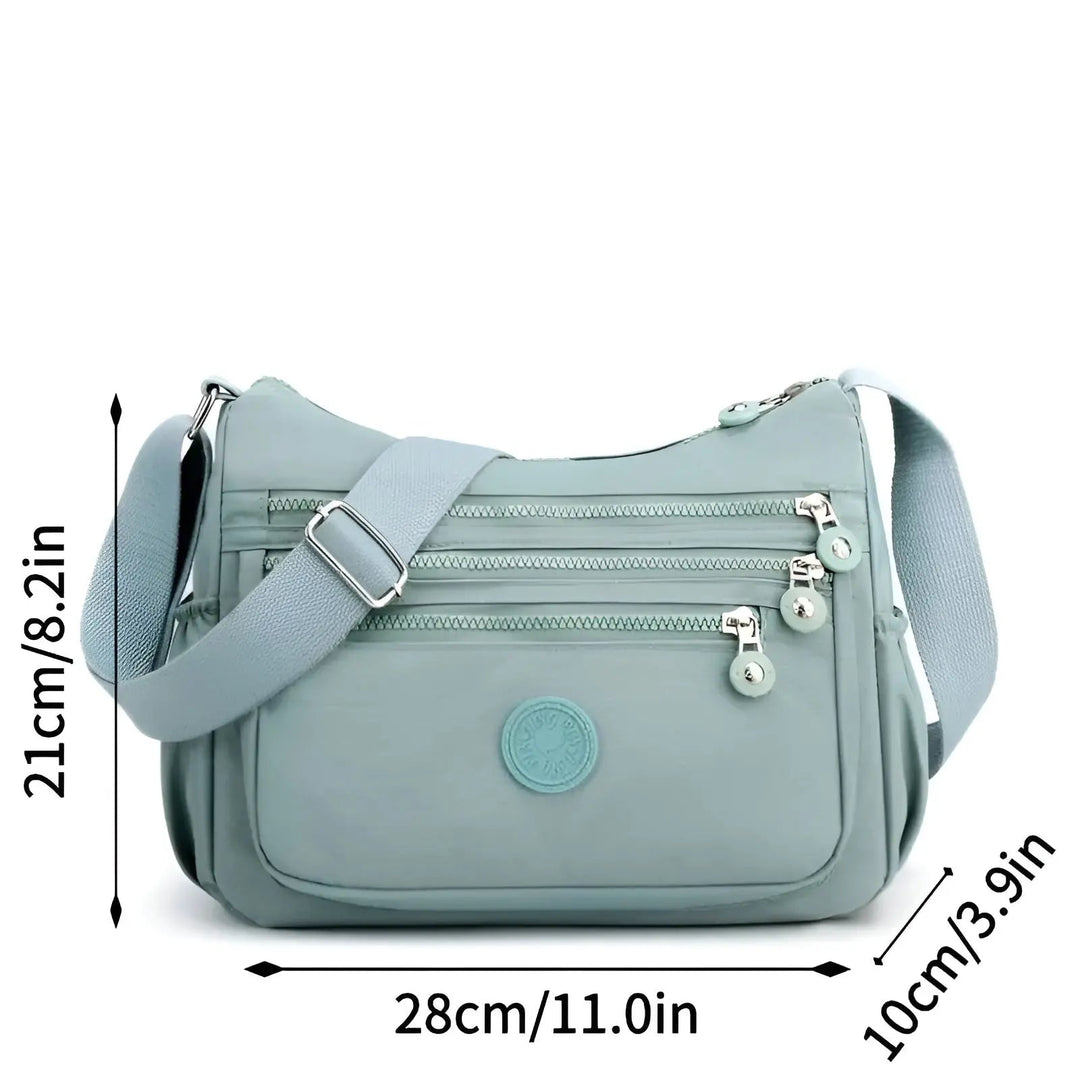 Sac bandoulière imperméable spacieux pour femmes, disponible en noir, violet, mauve, idéal pour un usage quotidien.