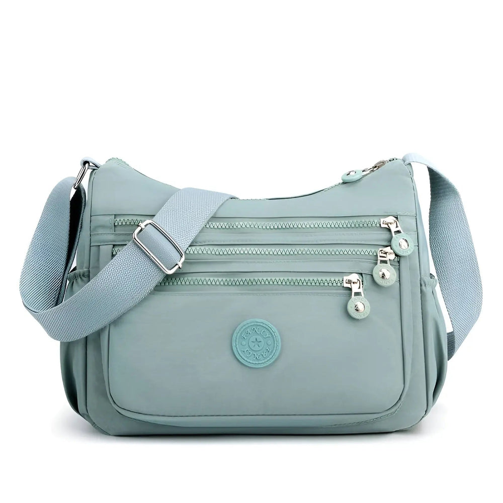 Sac bandoulière femme violet, imperméable et organisé, un accessoire de mode spacieux pour toutes saisons.