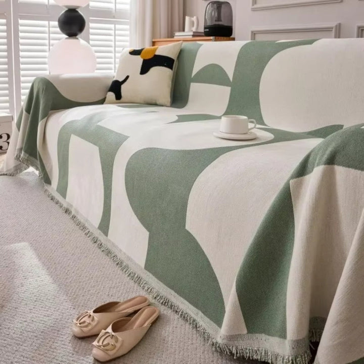 Housse de canapé extensible motif géométrique, protège et décore votre salon avec une touche bohème.