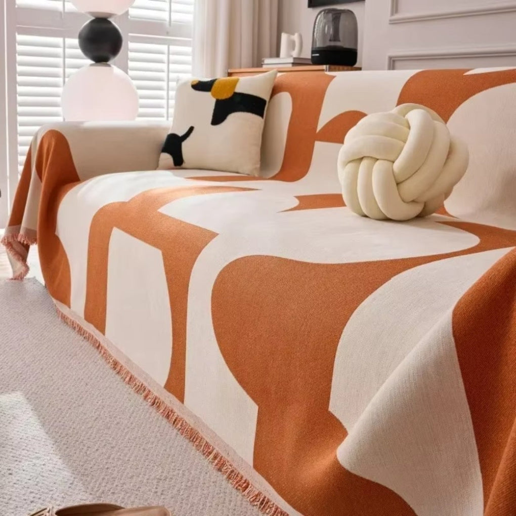 Couverture de canapé motif géométrique, idéal pour relooker votre salon et le protéger avec style.