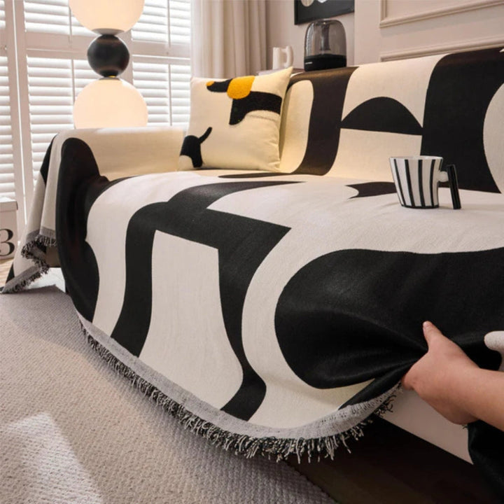 Accessoire maison : housse de canapé géométrique, style bohème, protection et élégance pour votre salon.