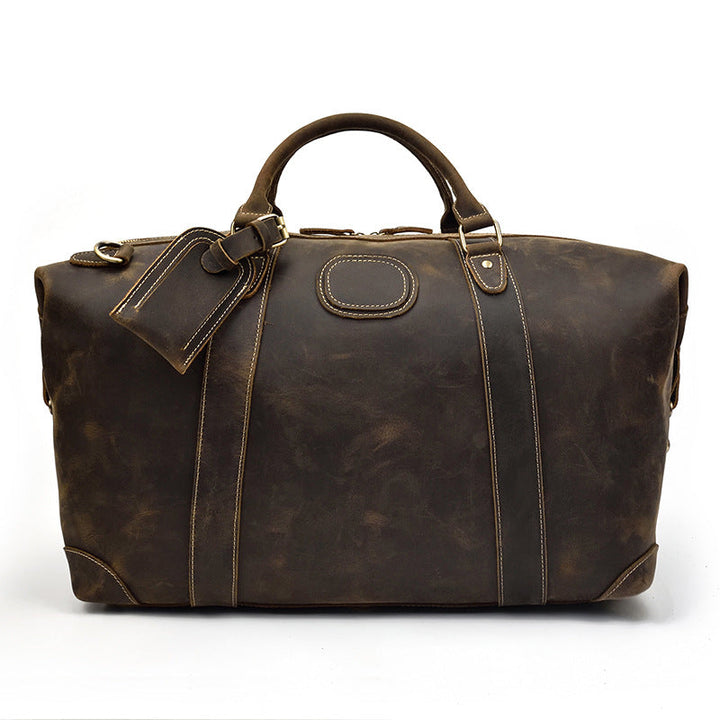 Grand sac duffel homme en cuir marron, parfait pour le voyage. Style vintage et robuste.