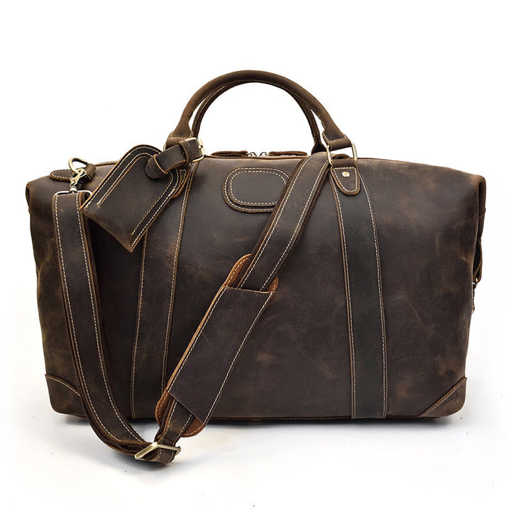 Sac de voyage duffel homme en cuir marron vintage, grande capacité, style authentique et robuste.