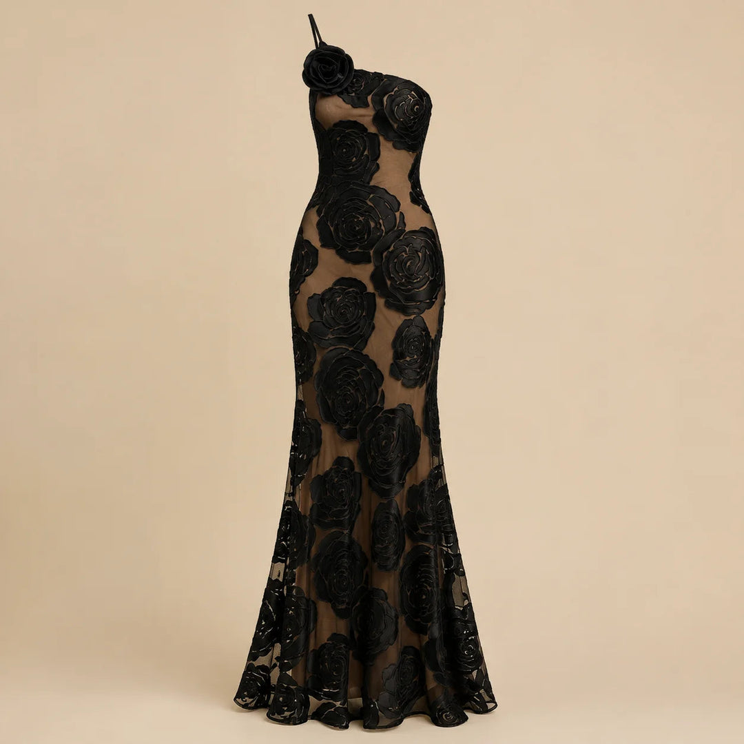 Maxi robe femme chic et asymétrique, ornée d'une fleur. Idéale pour un événement, une soirée élégante ou un cocktail.
