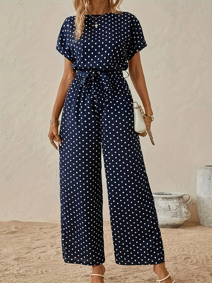 Jumpsuit femme chic à pois, taille haute, coupe large fluide. Parfaite pour l'été, look décontracté et élégant.