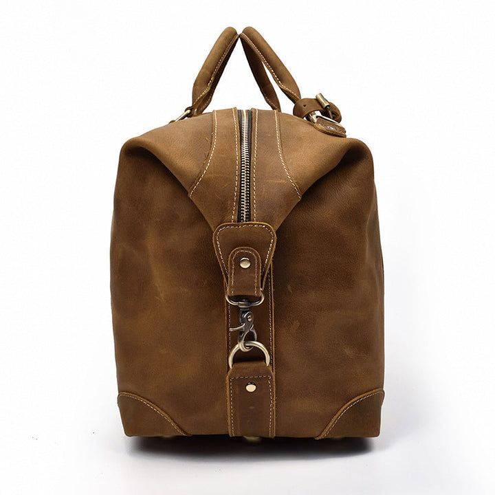 Robuste sac duffel de voyage homme en cuir marron vintage, grande capacité pour toutes les aventures.