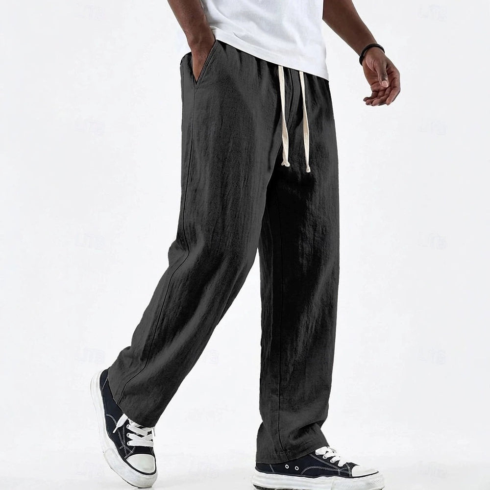 Gros plan sur la taille élastique et le cordon du pantalon large décontracté homme, pour un ajustement facile.