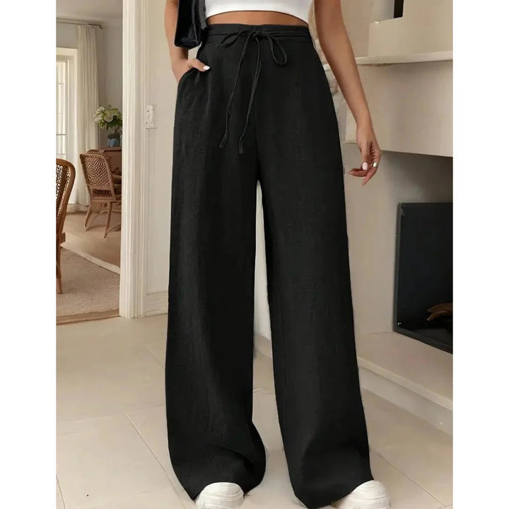 Pantalon large et fluide pour femme, parfait pour le printemps-été. Taille haute à cordon, poches latérales. Style décontracté chic.