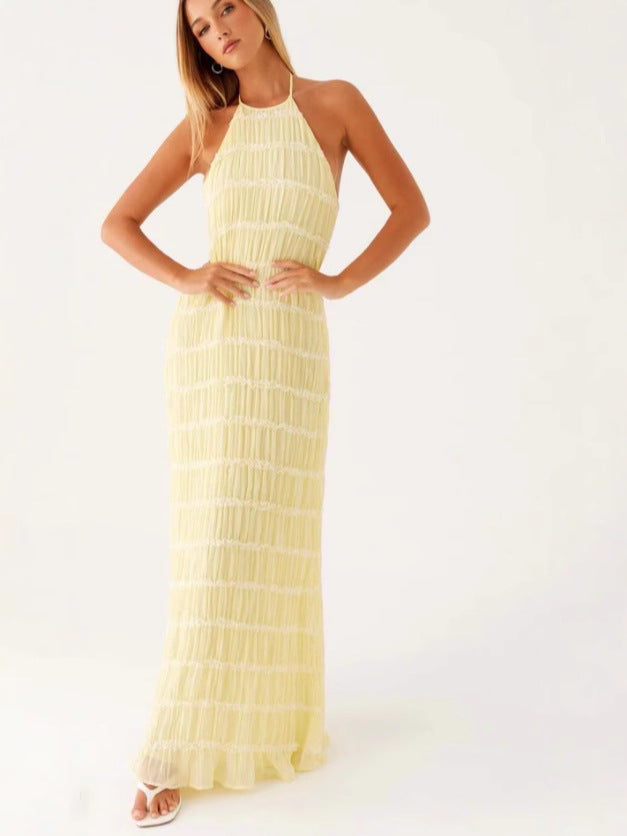 Robe de soirée maxi plissée pour femme, coupe halter et dos nu. Élégance fluide pour printemps/été.