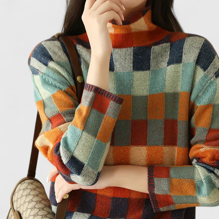Pull femme élégant à motifs carreaux multicolores vibrants, parfait pour une tenue décontractée chic.