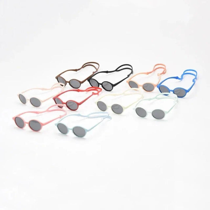 Lunettes de soleil bébé flexibles et durables, protection UV400 optimale, sangle de maintien.