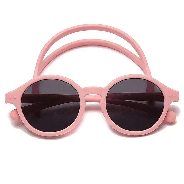 Accessoire bébé: lunettes soleil souples UV400, sangle réglable, protège les yeux délicats.