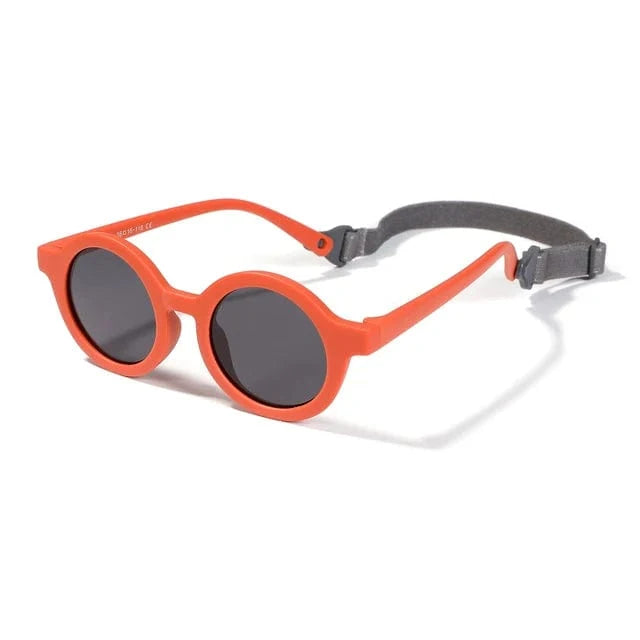 Lunettes de soleil rondes enfant avec sangle, protection UV. Idéales pour bébés, confortables et sécurisées.