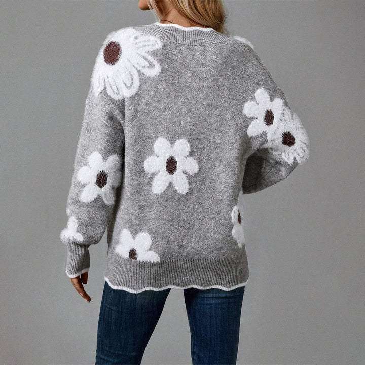 Pull femme confortable à manches longues avec un motif fleuri texturé distinctif. Idéal pour l'hiver chic.