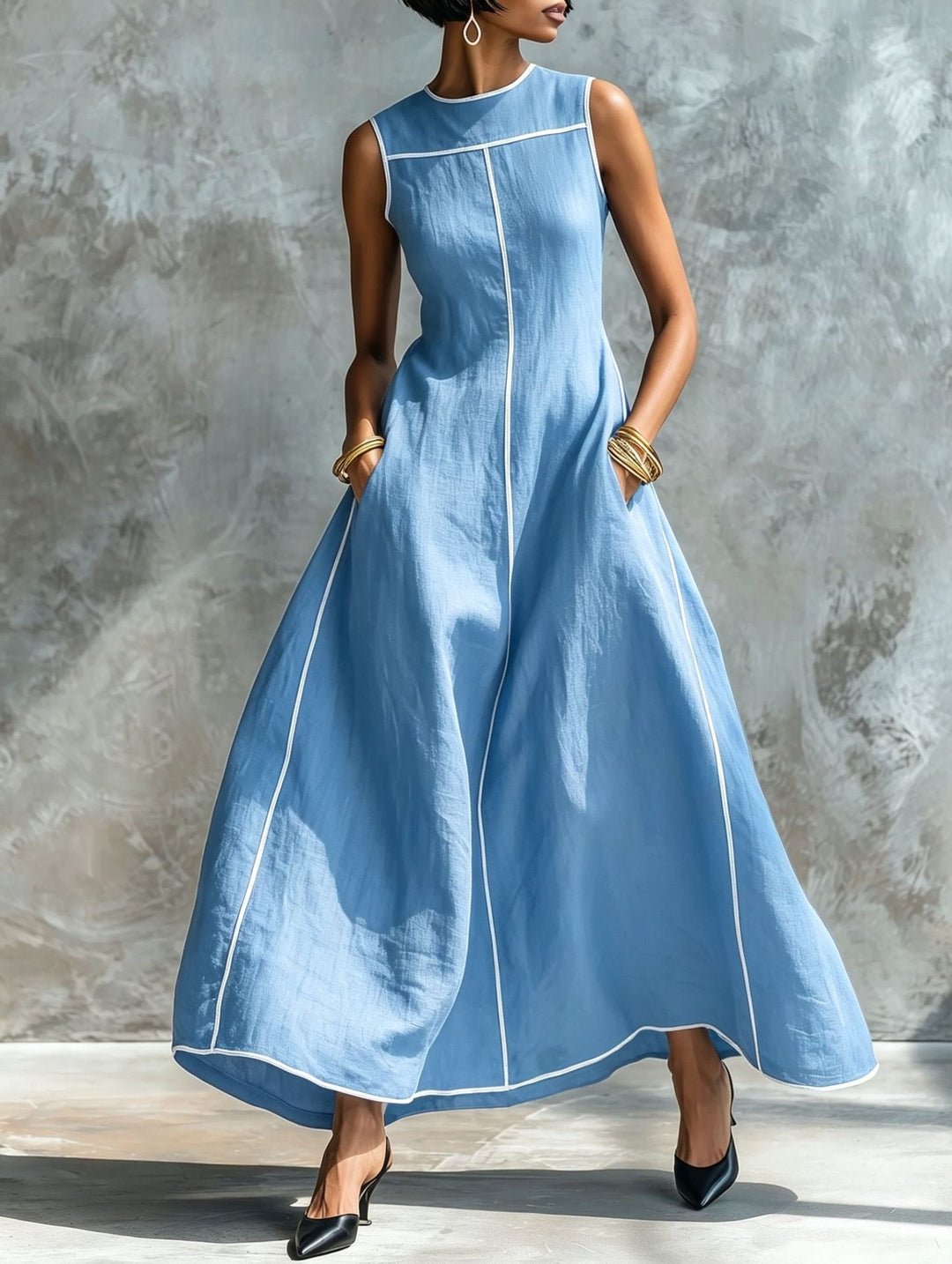 Magnifique robe femme longue et fluide, sans manches, style minimaliste, pour une élégance intemporelle au printemps.