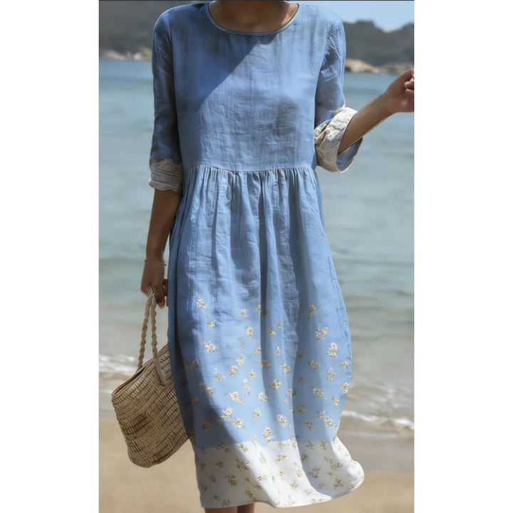 Robe midi femme fluide à manches courtes, col rond. Idéale pour un look décontracté chic au printemps et en été.