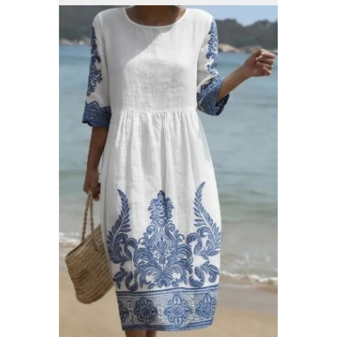 Robe femme midi confortable et chic, coupe fluide, col rond. Manches courtes. Tendance mode printemps-été.
