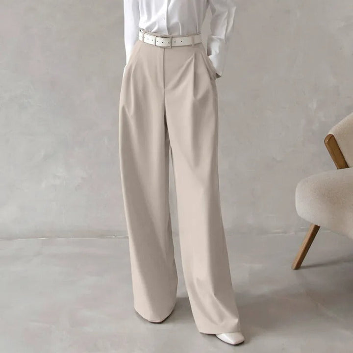 Pantalon de tailleur femme sophistiqué, coupe jambe large fluide, taille haute flatteuse pour une silhouette élégante.