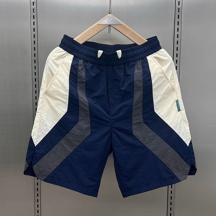 Short de sport homme Diego avec design géométrique contrasté. Confort optimal pour l'entraînement.