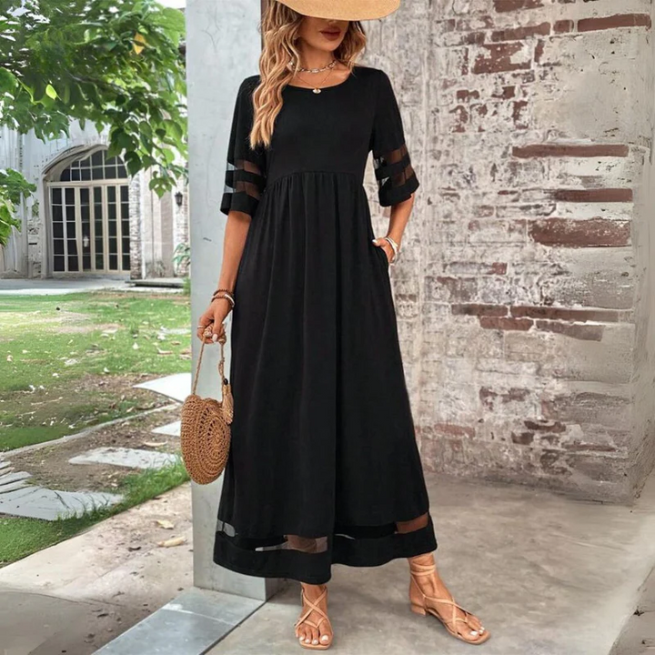 Robe femme fluide élégante, longueur midi, manches 3/4, détails transparents, idéale pour le printemps/été.
