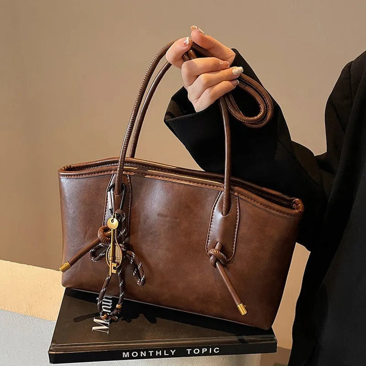 Sac à bandoulière femme structuré en cuir synthétique, élégant, idéal pour le bureau et le quotidien.