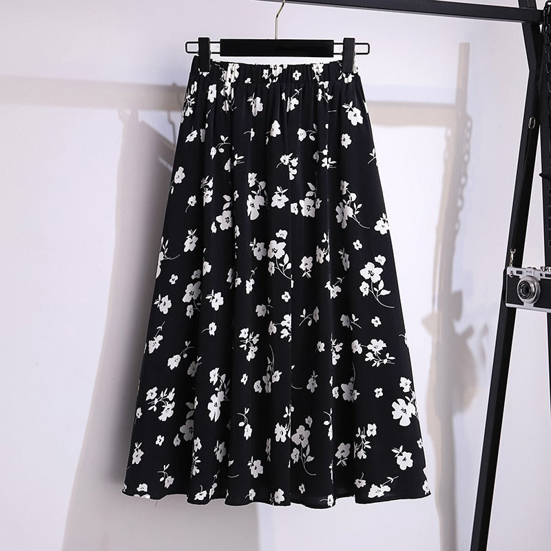 Jupe midi fluide florale femme avec taille élastique, confort et élégance. Parfaite pour l'été, style tendance décontracté.