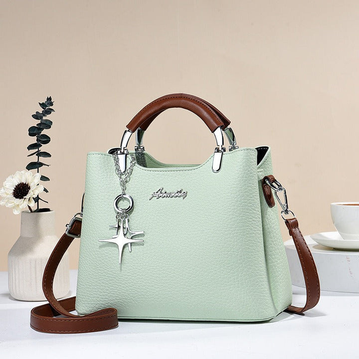 Sac à main polyvalent en simili-cuir, style élégant et moderne pour femme, usage quotidien.