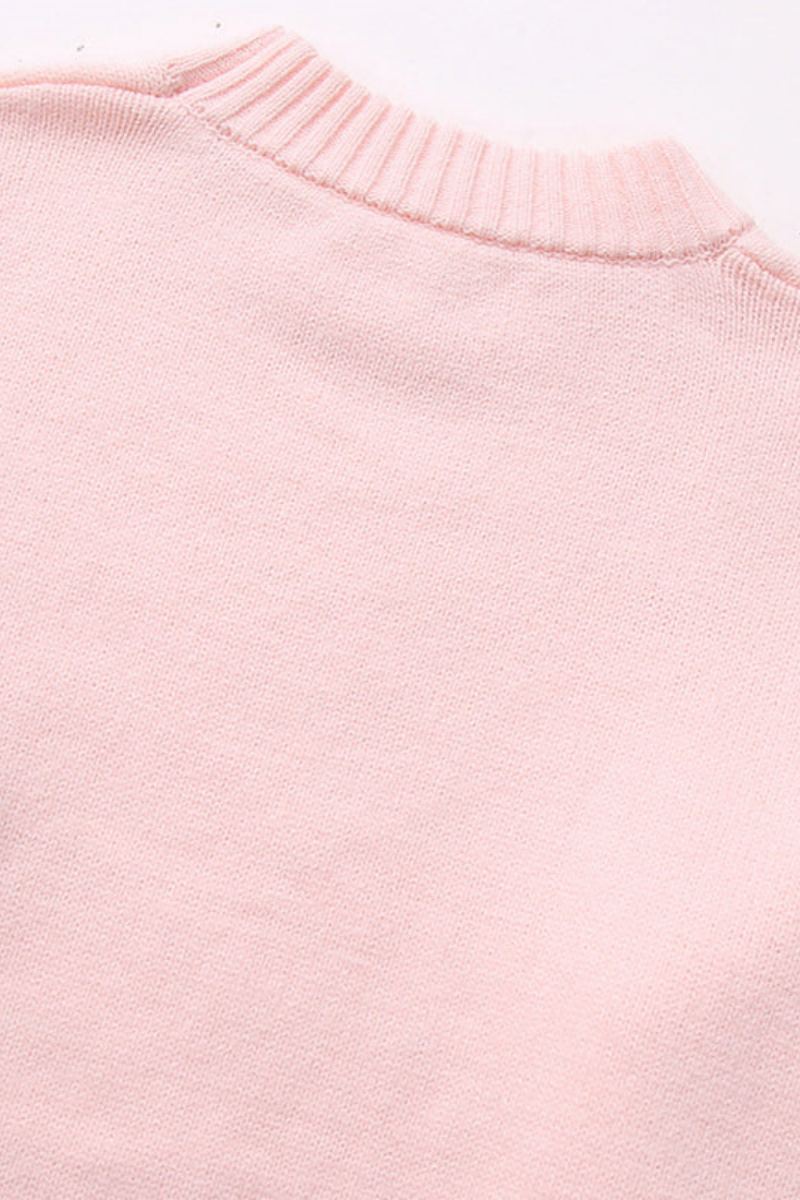 Pull ample rose poudré pour femme, col rond. Un basique décontracté et chic pour la mi-saison.