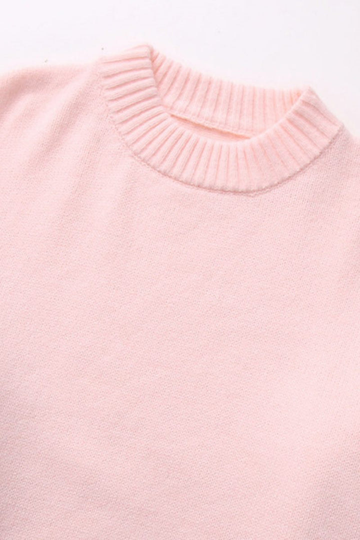 Pull rose ultra-confortable pour femme, coupe ample et col rond. Parfait pour un look mode hivernal.