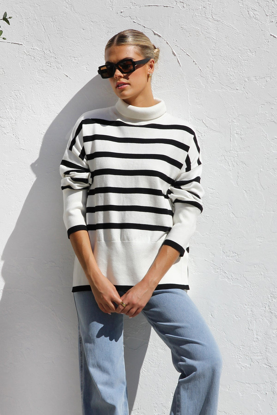 Pull femme en maille oversize à rayures intemporelles. Col montant douillet, style hiver chic et moderne.