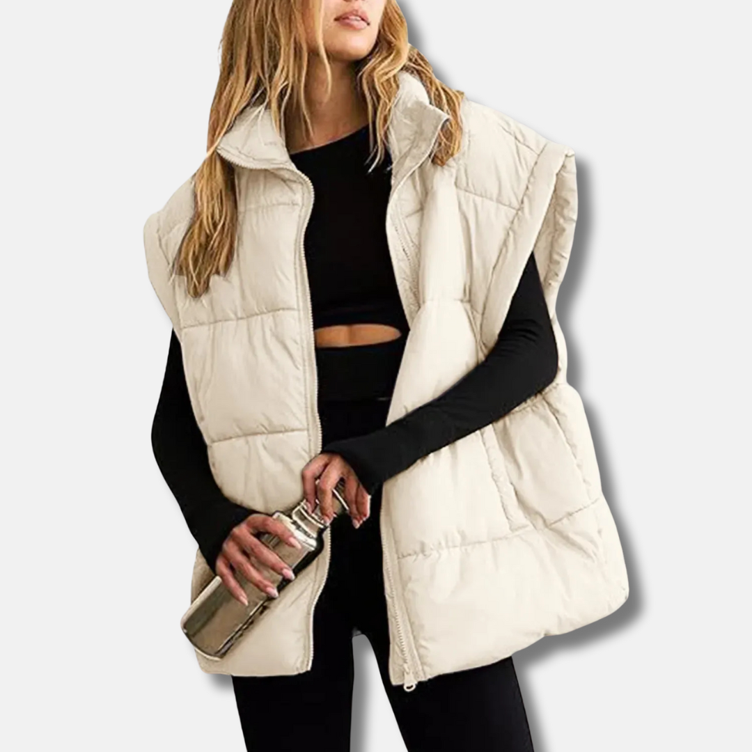 Veste urbaine matelassée femme, col montant, sans manches. Légère et chaude pour un look chic en automne.