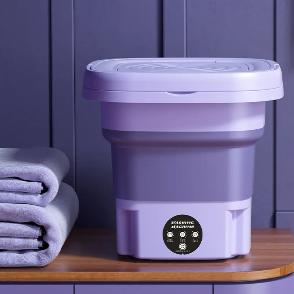 Lave-linge portable pliable violet avec essorage intégré, idéal voyage, camping et petit appartement.