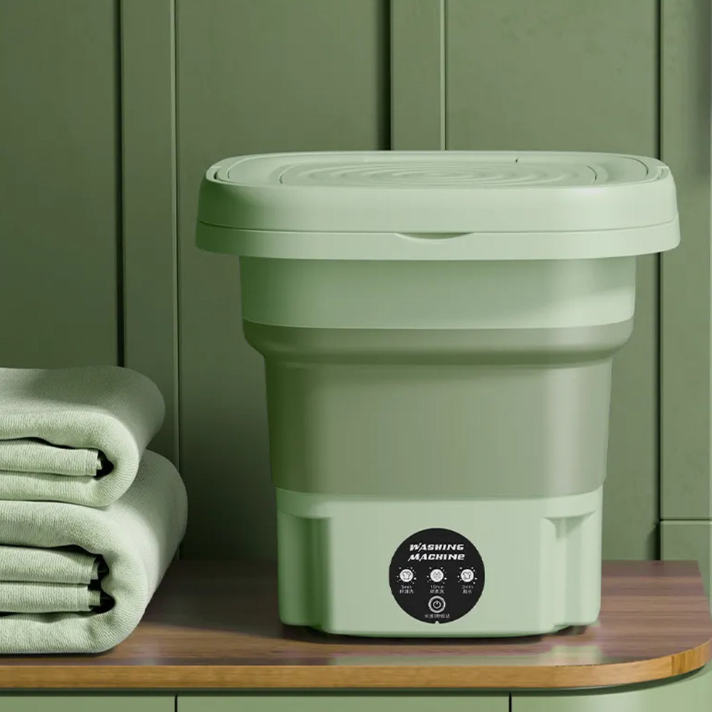Mini machine à laver compacte verte, parfaite pour studio et camping. Se plie facilement pour rangement.