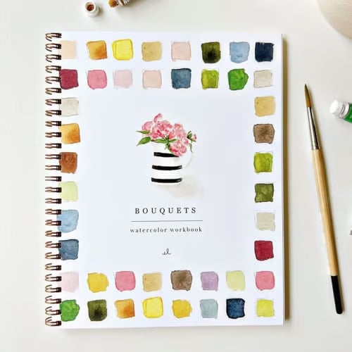 Ouverture du manuel d'aquarelle, montrant des techniques simples pour démarrer l'art pas à pas.