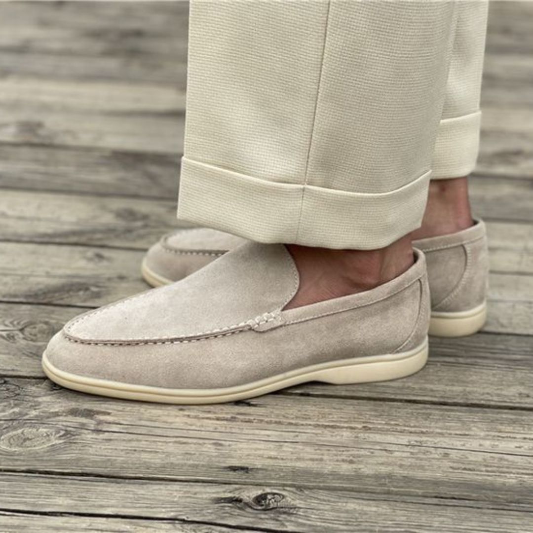 Gros plan sur la texture du cuir des mocassins homme, détails des finitions élégantes et robustes.