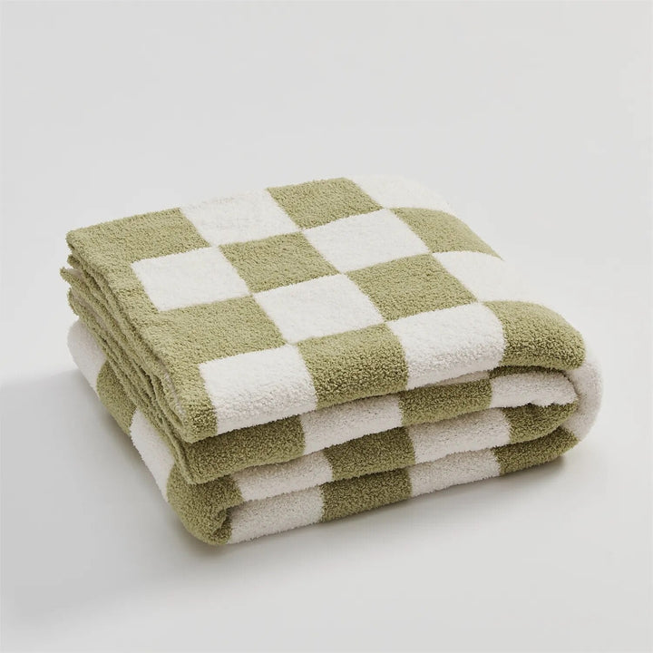 Couverture douillette à carreaux pour un confort optimal dans le salon ou comme jeté de lit.