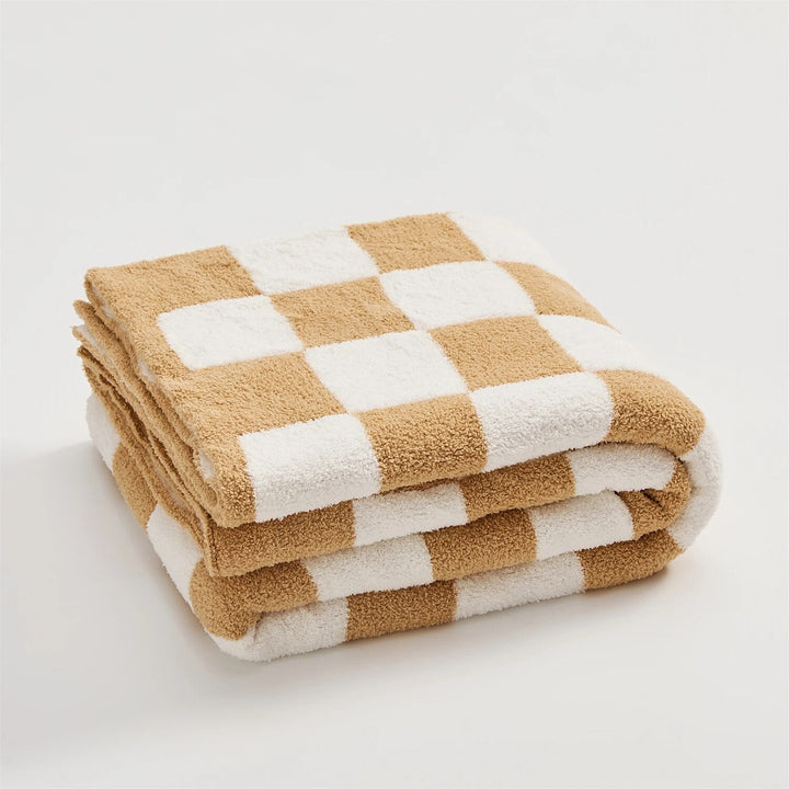 Couverture en plaid à carreaux vifs, ajoute une touche colorée et chaleureuse au salon.
