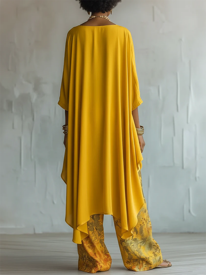 Tenue d'été bohème chic femme : ensemble fluide décontracté avec pantalon floral et haut asymétrique, parfait vacances.