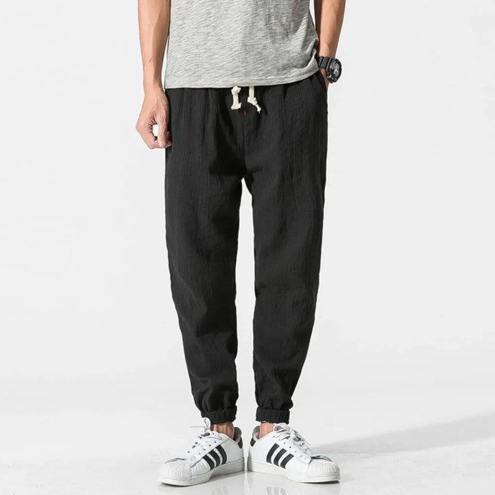 Pantalon homme noir, taille élastique, léger, respirant. Confort quotidien assuré, mode casual pour l'été.