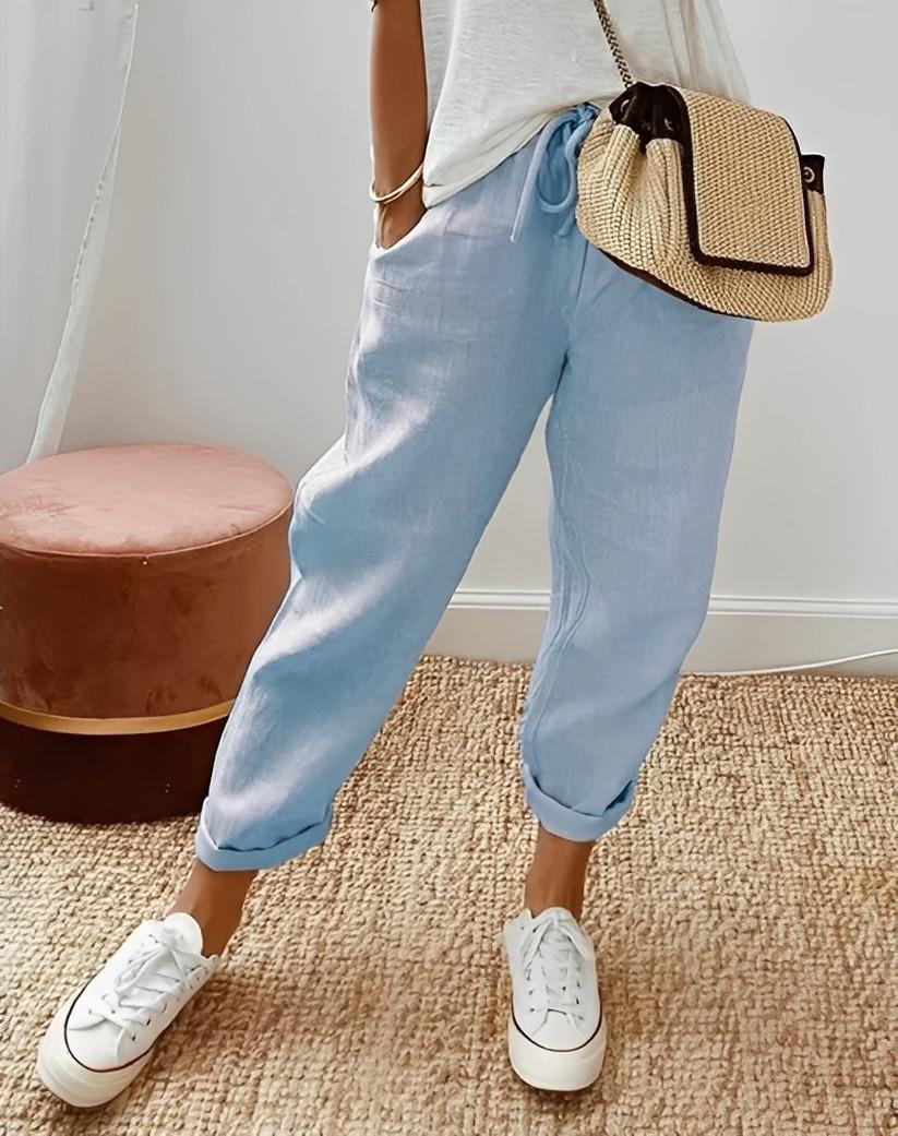 Pantalon d'été en lin fluide pour femme, coupe décontractée avec poches et jambes larges.