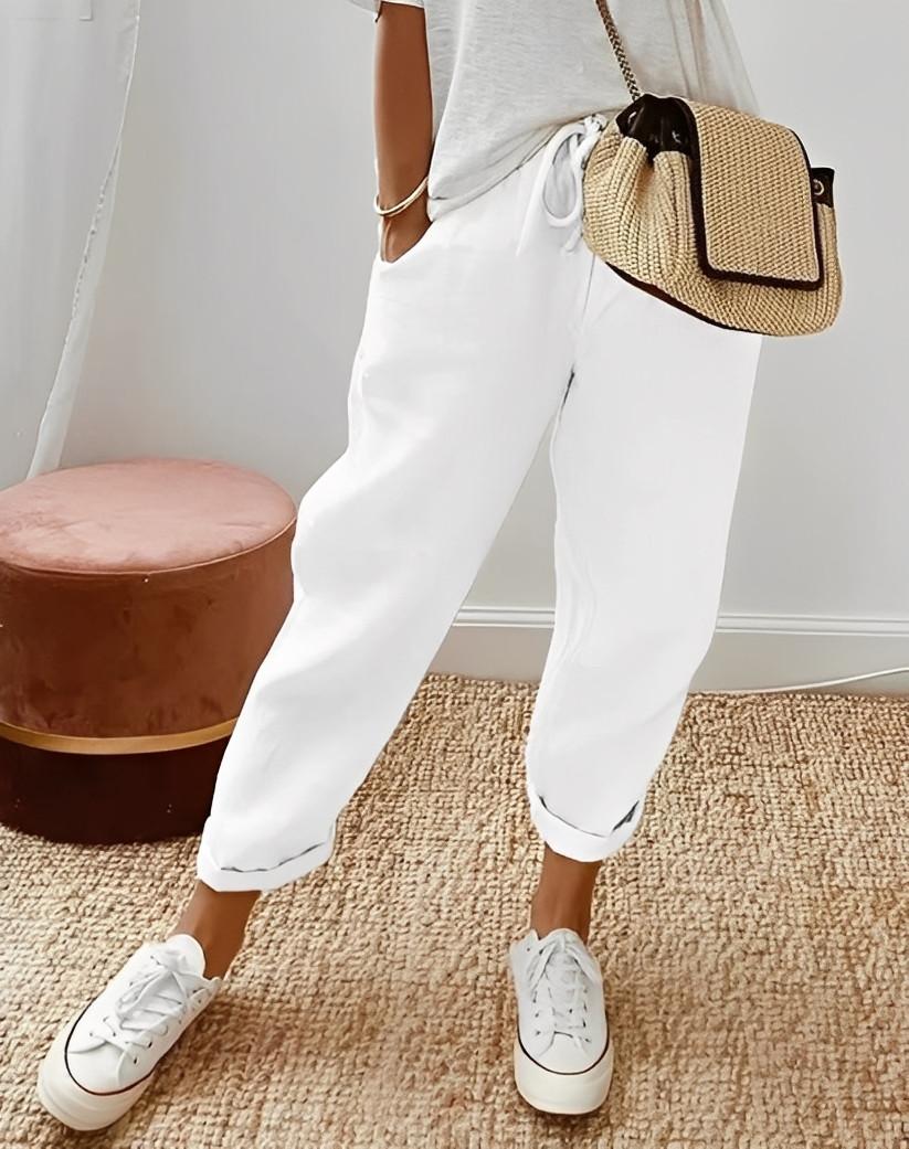 Pantalon large femme en lin respirant, taille élastique pour un confort estival chic.