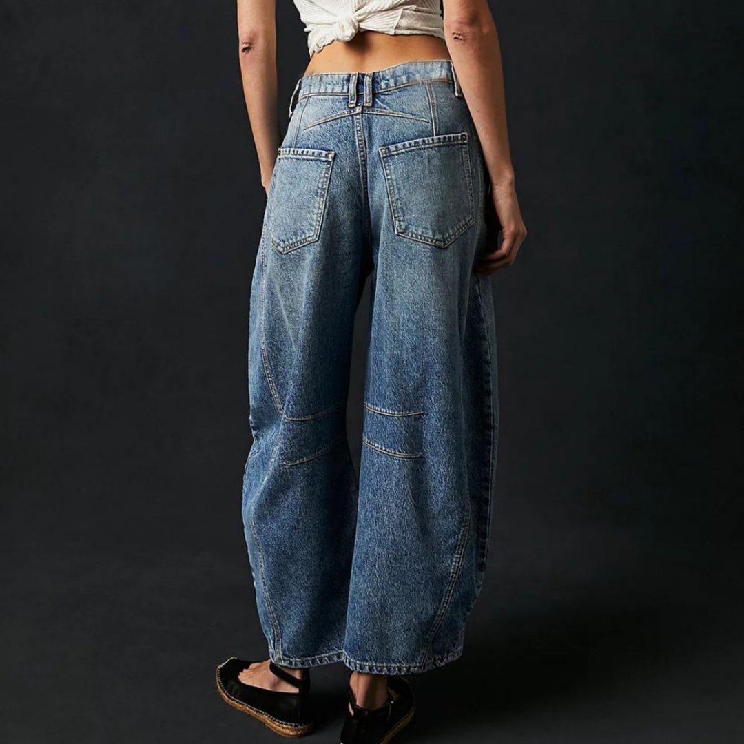 Femme marchant en pantalon large denim, style ample et élégant pour le printemps.