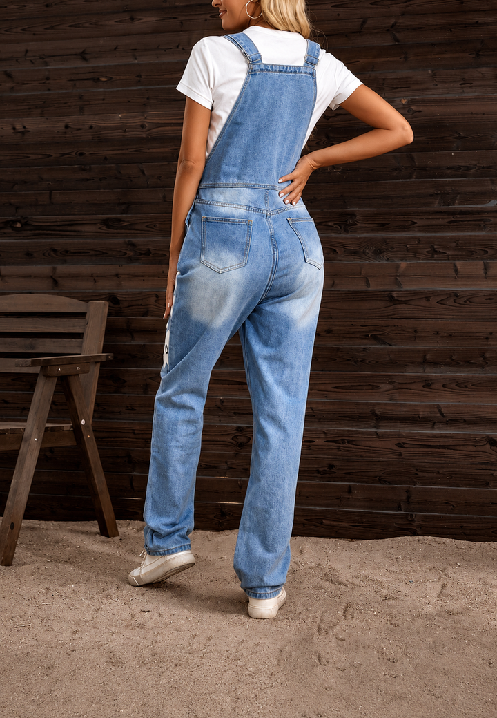 Vêtement féminin unique: salopette en jean avec motif floral, idéale pour la mode décontractée et estivale.